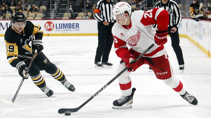 Oct 1, 2024; Pittsburgh, Pennsylvania, USA;  Detroit Red Wings right wing Michael Brandsegg-Nygård (28) skates with the puck as Pittsburgh Penguins center Cody Glass (19) chases during the second period at PPG Paints Arena. Mandatory Credit: Charles LeClaire-Imagn Images