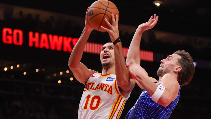 Nov 4, 2025; Atlanta, Georgia, USA; Atlanta Hawks forward Zaccharie Risacher (10) shoots past Orlando Magic forward Franz Wagner (22) in the fourth quarter at State Farm Arena. Mandatory Credit: Brett Davis-Imagn Images
