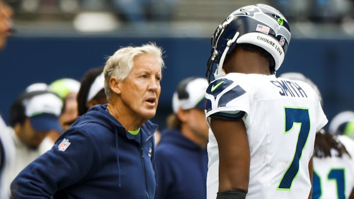 Sep 24, 2023; Seattle, Washington, USA; Seattle Seahawks head coach Pete Carroll talks with quarterback Geno Smith (7) following a three-and-out against the Carolina Panthers during the second quarter at Lumen Field. Mandatory Credit: Joe Nicholson-Imagn Images