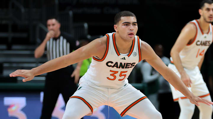 Nov 23, 2025; Coral Gables, Florida, USA; Miami Hurricanes guard Dante Allen (35) defends against Delaware State Hornets guard Ponce James (1) during the first half at Watsco Center. Mandatory Credit: Sam Navarro-Imagn Images