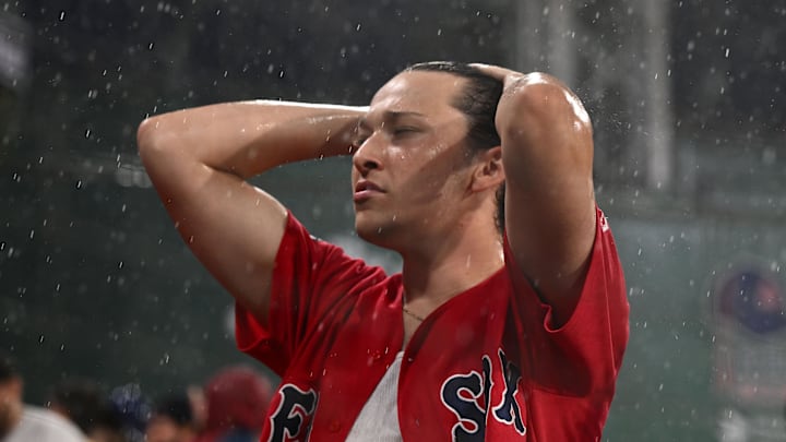 Jun 28, 2023; Boston, Massachusetts, USA; A Boston Red Sox fan reacts during a rain delay in a game against the Miami Marlins at Fenway Park. Mandatory Credit: Brian Fluharty-Imagn Images