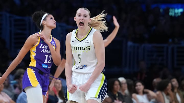 Aug 20, 2025; Los Angeles, California, USA; Dallas Wings guard Paige Bueckers (5) celebrates in the second half as LA Sparks guard Rae Burrell (12) watches at Crypto.com Arena. Mandatory Credit: Kirby Lee-Imagn Images