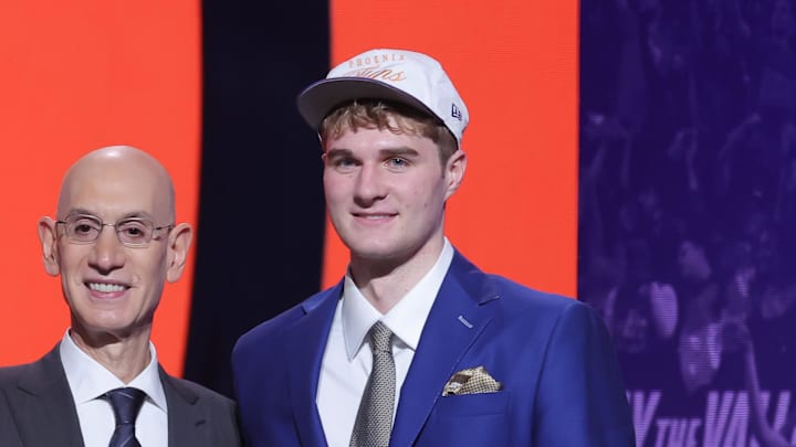 Jun 25, 2025; Brooklyn, NY, USA;  Liam McNeeley stands with NBA commissioner Adam Silver after being selected as the 29th pick by the Phoenix Suns in the first round of the 2025 NBA Draft at Barclays Center. Mandatory Credit: Brad Penner-Imagn Images