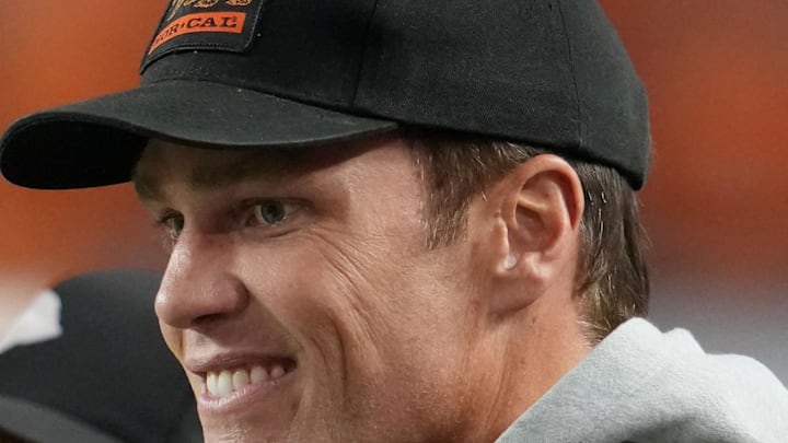 Jan 19, 2026; Miami Gardens, FL, USA; Tom Brady looks on from the sideline before the CFP National Championship college football game between the Indiana Hoosiers and the Miami Hurricanes at Hard Rock Stadium. Mandatory Credit: Kirby Lee-Imagn Images
