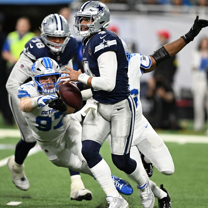 Dallas Cowboys quarterback Dak Prescott is pressured by Detroit Lions defenders Al-Quadin Muhammad and Aidan Hutchinson 