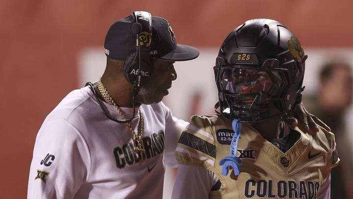Oct 25, 2025; Salt Lake City, Utah, USA; Colorado Buffaloes head coach Deion Sanders speaks with Colorado Buffaloes wide receiver Isaiah Hardge (17) before the game against the Utah Utes at Rice-Eccles Stadium. Mandatory Credit: Rob Gray-Imagn Images