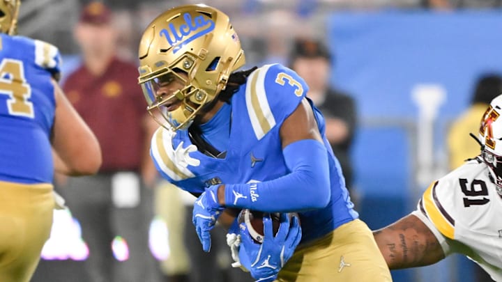 Oct 12, 2024; Pasadena, California, USA; UCLA Bruins wide receiver Kwazi Gilmer (3) runs past Minnesota Golden Gophers defensive lineman Deven Eastern (91) during the second quarter  at Rose Bowl. Mandatory Credit: Robert Hanashiro-Imagn Images