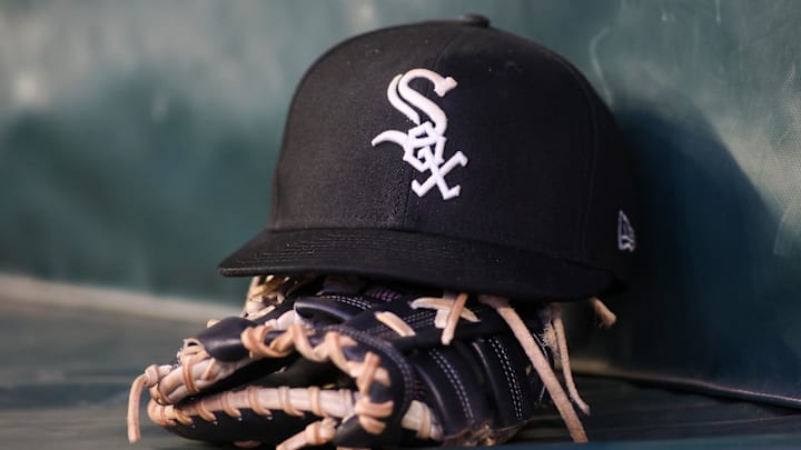 Jul 14, 2023; Atlanta, Georgia, USA; A detailed view of a Chicago White Sox hat and glove in the dugout against the Atlanta Braves in the fourth inning at Truist Park. 