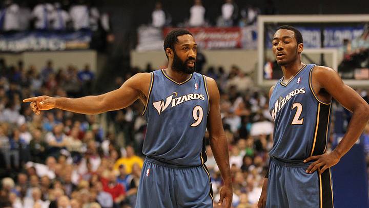 Oct 5, 2010; Dallas, TX, USA; Washington Wizards guard Gilbert Arenas (9) talks with guard John Wall (2) in the second quarter against the Dallas Mavericks at American Airlines Center. Mandatory Credit: Matthew Emmons-Imagn Images Oct 5, 2010; Dallas, TX, USA; Washington Wizards guard Gilbert Arenas (9) talks with guard John Wall (2) in the second quarter against the Dallas Mavericks at American Airlines Center. Mandatory Credit: Matthew Emmons-Imagn Images