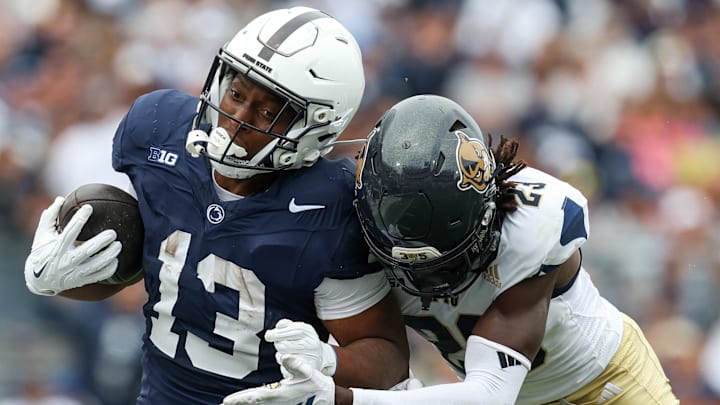 Sep 6, 2025; University Park, Pennsylvania, USA; Penn State Nittany Lions running back Kaytron Allen (13) runs with the ball before being pushed out of bounds by Florida International Panthers defensive back Jessiah McGrew (23) during the first quarter at Beaver Stadium. Mandatory Credit: Matthew O'Haren-Imagn Images