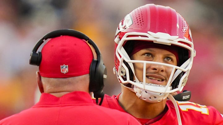 Sep 28, 2025; Kansas City, Missouri, USA; Kansas City Chiefs quarterback Patrick Mahomes (15) talks with head coach Andy Reid during the second half against the Baltimore Ravens at GEHA Field at Arrowhead Stadium. Mandatory Credit: Jay Biggerstaff-Imagn Images