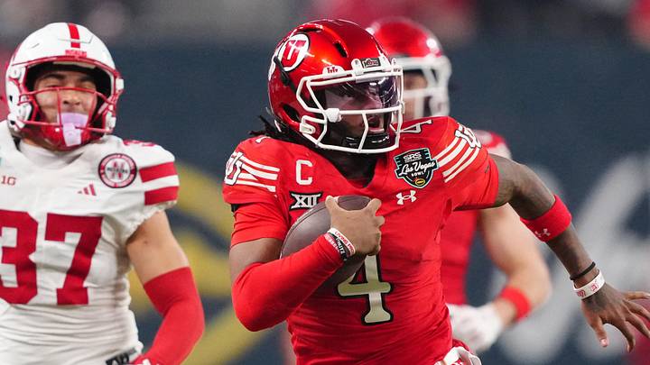 Utah Utes quarterback Devon Dampier (4) carries the ball against Nebraska Cornhuskers defensive back Donovan Jones (37) in the second half during the SRS Distribution Las Vegas Bowl at Allegiant Stadium. 