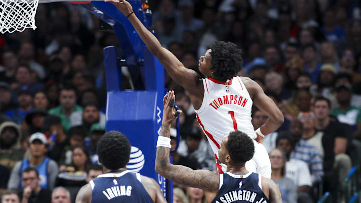 Oct 31, 2024; Dallas, Texas, USA;  Houston Rockets forward Amen Thompson (1) scores over Dallas Mavericks forward P.J. Washington (25) during the second half at American Airlines Center. Mandatory Credit: Kevin Jairaj-Imagn Images