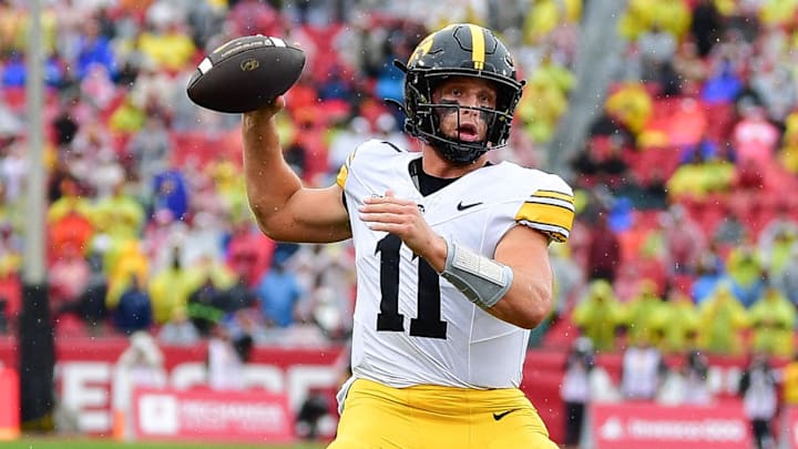 Nov 15, 2025; Los Angeles, California, USA; Iowa Hawkeyes quarterback Mark Gronowski (11) throws a touchdown pass against the Southern California Trojans during the first half at the Los Angeles Memorial Coliseum. Mandatory Credit: Gary A. Vasquez-Imagn Images