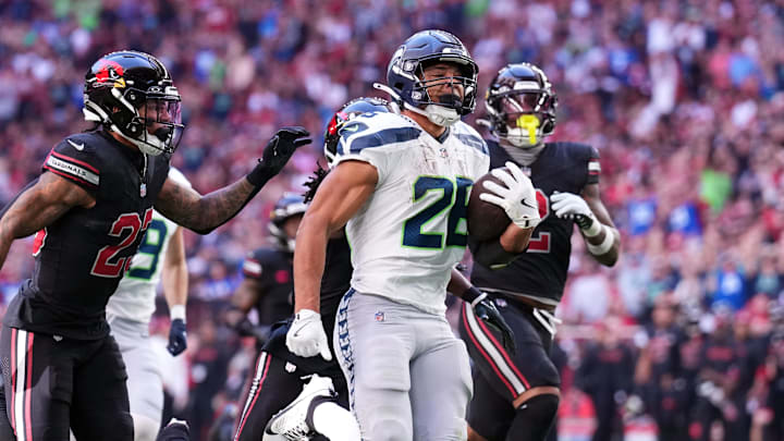 Dec 8, 2024; Glendale, Arizona, USA; Seattle Seahawks running back Zach Charbonnet (26) runs for a touchdown against the Arizona Cardinals during the first half at State Farm Stadium. Mandatory Credit: Joe Camporeale-Imagn Images