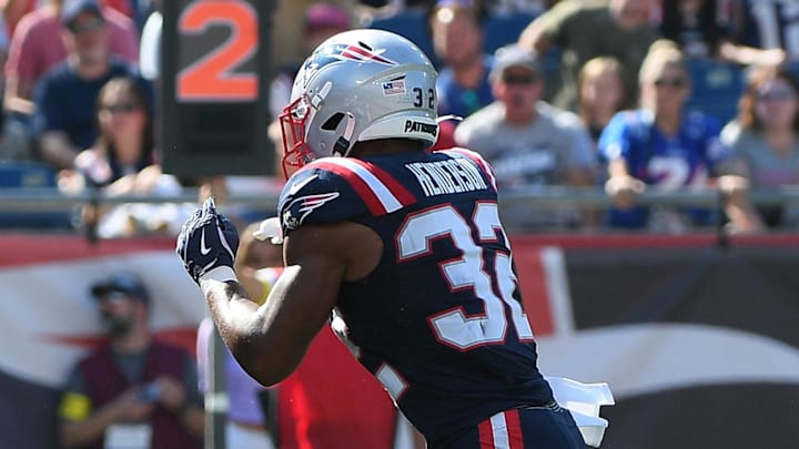 Sep 28, 2025; Foxborough, Massachusetts, USA; New England Patriots running back Treveyon Henderson (32) runs the ball for a touchdown during the first half against the Carolina Panthers at Gillette Stadium. Mandatory Credit: Bob DeChiara-Imagn Images