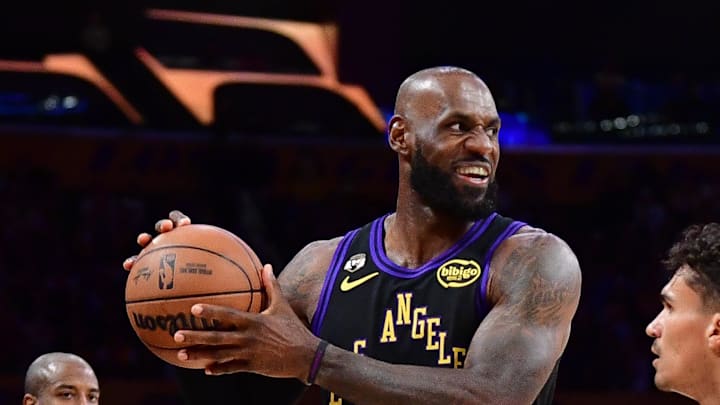 Los Angeles Lakers forward LeBron James controls the ball against Orlando Magic forward Tristan da Silva.