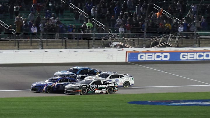 May 5, 2024; Kansas City, Kansas, USA;  NASCAR Cup Series drivers Kyle Larson (5) and Chris Buescher (17) battle for the lead on the final lap off the Advent Health 400 at the Kansas Speedway.
