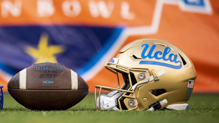 Dec 30, 2022; El Paso, Texas, USA; Helmets of the Pittsburgh Panthers and UCLA Bruins are posed in front of the logo before the 2022 Sun Bowl at Sun Bowl. Mandatory Credit: Ivan Pierre Aguirre-Imagn Images