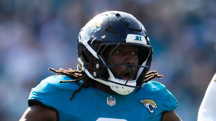 Jacksonville Jaguars linebacker Devin Lloyd celebrates a fumble recovery with cornerback Montaric Brown.