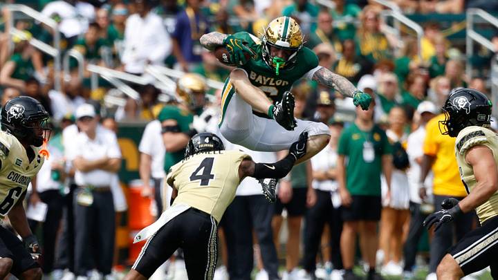 Sep 26, 2026; Waco, Texas, USA; Baylor Bears wide receiver Gavin Freeman (6) hurdles Colorado Buffaloes defensive back Naeten Mitchell (4) during the second half at McLane Stadium. Mandatory Credit: Chris Jones-Imagn Images Sep 26, 2026; Waco, Texas, USA; Baylor Bears wide receiver Gavin Freeman (6) hurdles Colorado Buffaloes defensive back Naeten Mitchell (4) during the second half at McLane Stadium. Mandatory Credit: Chris Jones-Imagn Images