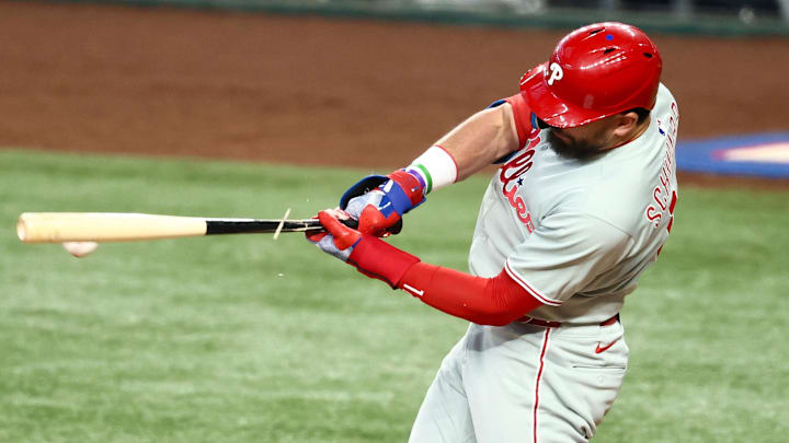 Aug 10, 2025; Arlington, Texas, USA;  Philadelphia Phillies designated hitter Kyle Schwarber (12) breaks his bat during the fourth inning against the Texas Rangers at Globe Life Field. 