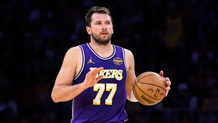 Mar 27, 2026; Los Angeles, California, USA; Los Angeles Lakers guard Luka Doncic (77) controls the ball during the second half against the Brooklyn Nets at Crypto.com Arena. Mandatory Credit: William Liang-Imagn Images