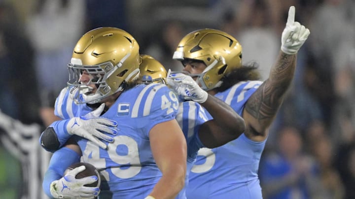 UCLA Bruins linebacker Carson Schwesinger and teammates celebrate after an interception in the second half against the Iowa Hawkeyes.