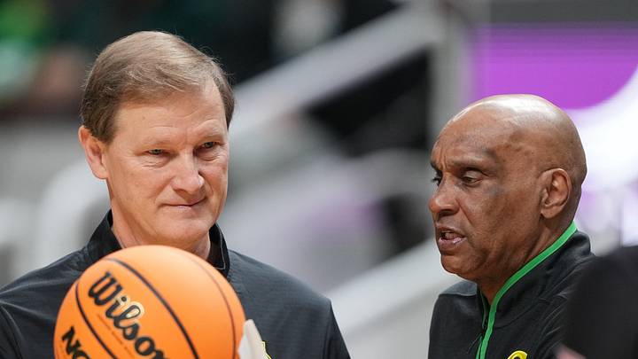 Dec 21, 2024; San Jose, California, USA; Oregon Ducks head coach Dana Altman (center) tosses the game ball with assistant coach Tony Stubblefield (right) during the first half against the Stanford Cardinal at SAP Center at San Jose.