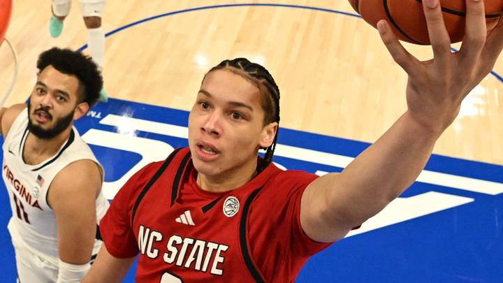 Mar 12, 2026; Charlotte, NC, USA; NC State Wolfpack guard Matt Able (3) scores as Virginia Cavaliers forward Devin Tillis (11) defends in the first half at Spectrum Center. Mandatory Credit: Bob Donnan-Imagn Images