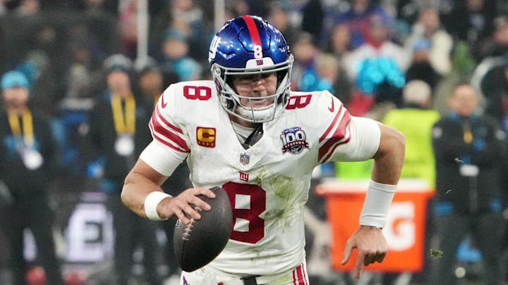 Nov 10, 2024; Munich, Germany; New York Giants quarterback Daniel Jones (8) carries the ball against the New York Giants in the second half during the 2024 NFL Munich Game at Allianz Arena. Mandatory Credit: Kirby Lee-Imagn Images