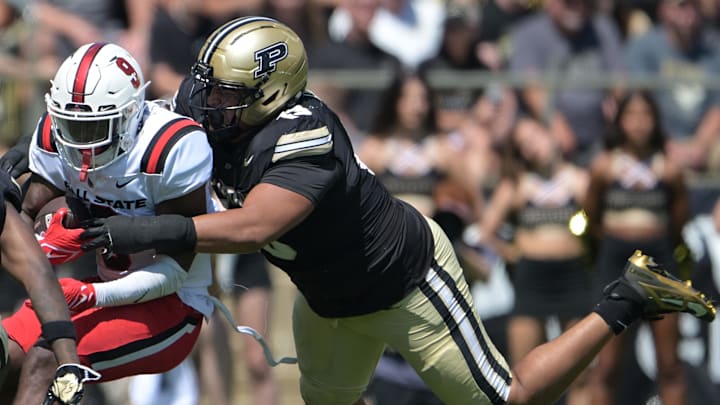Ball State Cardinals running back Qua Ashley (9) is tackled by Purdue Boilermakers defensive lineman TJ Lindsey (13) Ball State Cardinals running back Qua Ashley (9) is tackled by Purdue Boilermakers defensive lineman TJ Lindsey (13)