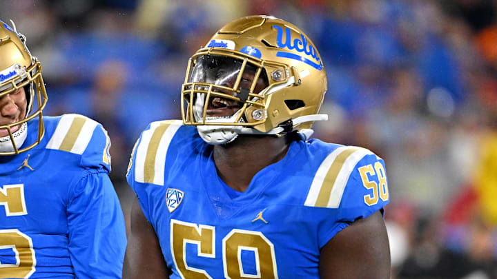 Oct 29, 2022; Pasadena, California, USA;  UCLA Bruins linebacker Laiatu Latu (15) and defensive lineman Gary Smith III (58) celebrate after a sack of Stanford Cardinal quarterback Tanner McKee (18)  in the first half at the Rose Bowl. Mandatory Credit: Jayne Kamin-Oncea-Imagn Images