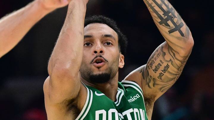 Oct 8, 2026; Cleveland, Ohio, USA;  Boston Celtics guard Devin Carter (99) shoots a three point shot over Cleveland Cavaliers guard Sam Merrill (5) during the first half of  preseason game at Rocket Arena.  Mandatory Credit: David Dermer-Imagn Images