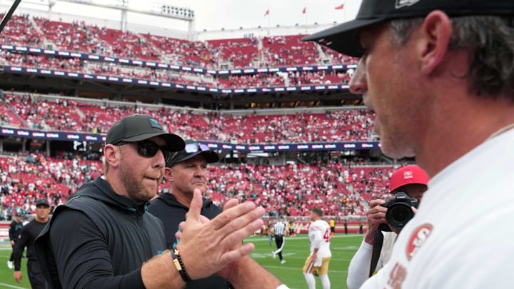 Sep 28, 2025; Santa Clara, California, USA; Jacksonville Jaguars head coach Liam Coen (center) shakes hands with San Francisco 49ers head coach Kyle Shanahan (right) after the game at Levi's Stadium. Mandatory Credit: Darren Yamashita-Imagn Images