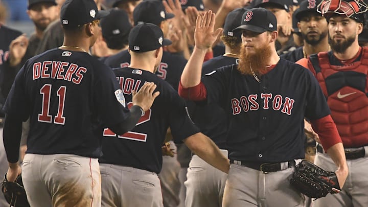 Boston Red Sox third baseman Rafael Devers (11) celebrates with pitcher Craig Kimbrel after defeating the Los Angeles Dodgers in game four of the 2018 World Series at Dodger Stadium. 