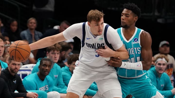 Oct 11, 2025; Dallas, Texas, USA; Dallas Mavericks forward Cooper Flagg (32) works on Charlotte Hornets forward Brandon Miller (24) in the first half of a game at American Airlines Center. Mandatory Credit: Raymond Carlin III-Imagn Images