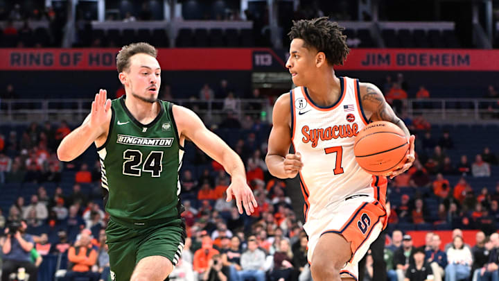 Nov 3, 2025; Syracuse, New York, USA; Syracuse Orange forward Kiyan Anthony (7) tries to move the ball past Binghamton Bearcats guard Jackson Benigni (24) in the second half at the JMA Wireless Dome. Mandatory Credit: Mark Konezny-Imagn Images