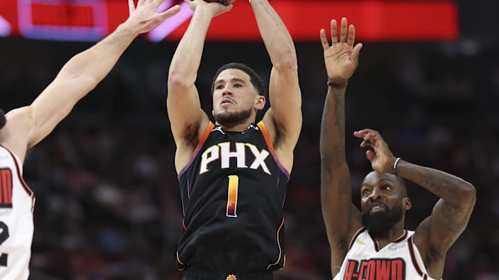 Mar 12, 2025; Houston, Texas, USA; Phoenix Suns guard Devin Booker (1) shoots the ball as Houston Rockets center Steven Adams (12) and forward Jeff Green (32) defend during the second quarter at Toyota Center. Mandatory Credit: Troy Taormina-Imagn Images