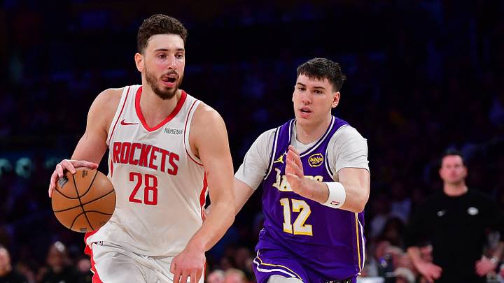 Apr 29, 2026; Los Angeles, California, USA; Houston Rockets center Alperen Sengun (28) moves the ball against Los Angeles Lakers forward Jake LaRavia (12) during the second half in game five of the first round of the 2026 NBA Playoffs at Crypto.com Arena. Mandatory Credit: Gary A. Vasquez-Imagn Images