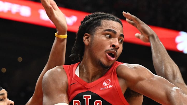Toronto Raptors forward Collin Murray-Boyles passes the ball away from Cleveland Cavaliers center Jarrett Allen.