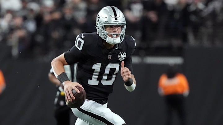 Dec 16, 2024; Paradise, Nevada, USA; Las Vegas Raiders quarterback Desmond Ridder (10) carries the ball against the Atlanta Falcons in the first half at Allegiant Stadium. Mandatory Credit: Kirby Lee-Imagn Images