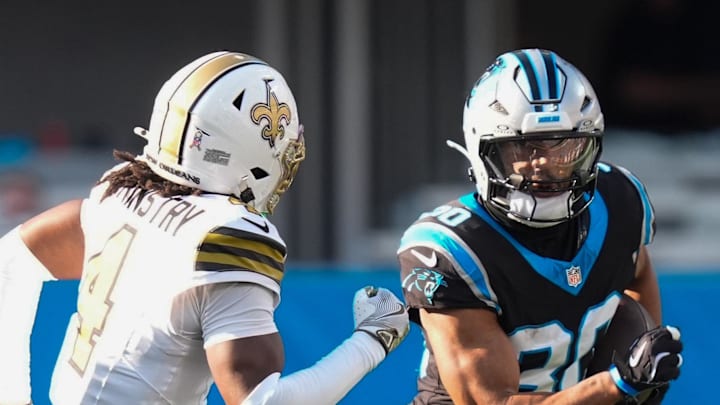 Carolina Panthers running back Chuba Hubbard rushes as New Orleans Saints cornerback Kool-Aid McKinstry defends.
