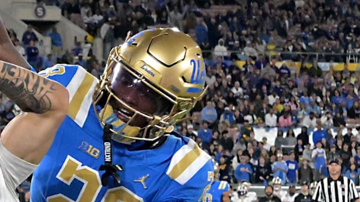 Nov 22, 2025; Pasadena, California, USA;  UCLA Bruins defensive back Scooter Jackson (28) breaks up a pass intended for Washington Huskies wide receiver Audric Harris (13) in the end zone during the first half at the Rose Bowl. Mandatory Credit: Jayne Kamin-Oncea-Imagn Images