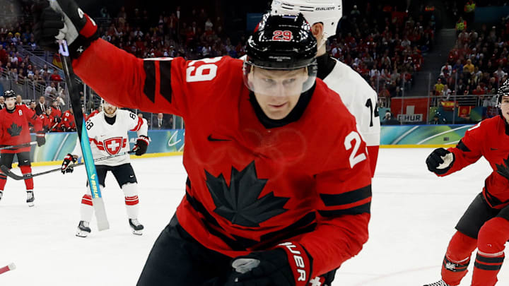 Feb 13, 2026; Milan, Italy; Nathan MacKinnon of Canada celebrates after scoring their fifth goal against Switzerland in men's ice hockey group A play during the Milano Cortina 2026 Olympic Winter Games at Milano Santagiulia Ice Hockey Arena. Mandatory Credit: Geoff Burke-Imagn Images