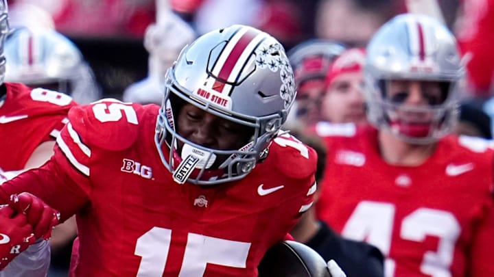 Ohio State Buckeyes tight end Jelani Thurman (15) runs past Rutgers Scarlet Knights defensive back Kaj Sanders (5) during the second half of the NCAA football game at Ohio Stadium in Columbus on Nov. 22, 2025. Ohio State won 42-9.
