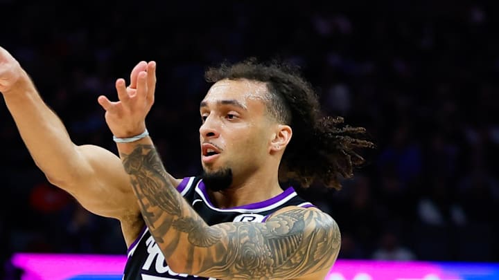 Jan 3, 2025; Sacramento, California, USA; Sacramento Kings guard Devin Carter (22) passes the ball against Memphis Grizzlies guard Scotty Pippen Jr. (1) during the first quarter at Golden 1 Center. Mandatory Credit: Sergio Estrada-Imagn Images