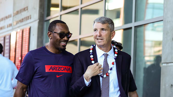 Nov 8, 2025; Tucson, Arizona, USA; Arizona Wildcats head coach Brent Brennan walks with the honorary captain Antoine Cason during the Wildcat Walk before the start of the game against the Kansas Jayhawks at Arizona Stadium. Mandatory Credit: Aryanna Frank-Imagn Images