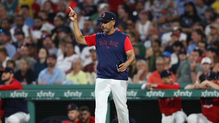 Jul 2, 2025; Boston, Massachusetts, USA; Boston Red Sox manager Alex Cora (13) makes a pitching change during the seventh inning against the Cincinnati Reds at Fenway Park. Mandatory Credit: Paul Rutherford-Imagn Images