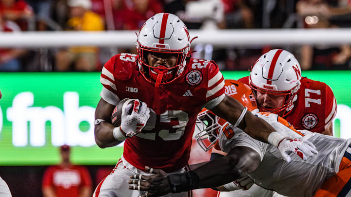 Running back, Dante Dowdell (23), runs through an Illinois defender on a run. 